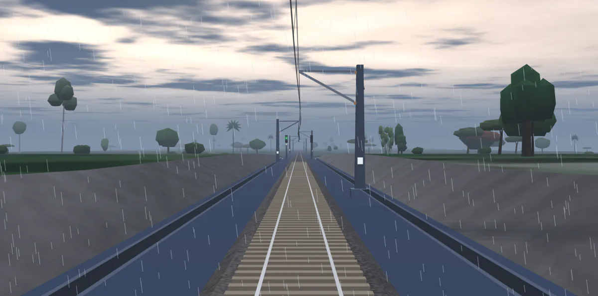Actual cab view in rain: grey cloud, falling rain and a cutting ahead under the overhead line, with a clear signal